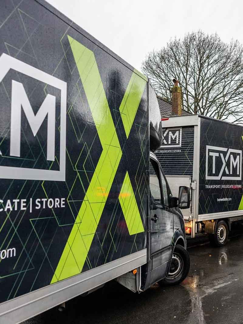 TXM removals vans at a house move in Worsley