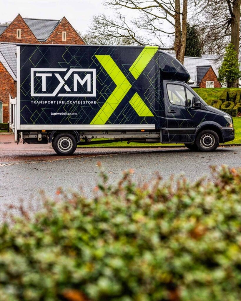 TXM removals vans at a house move in Worsley